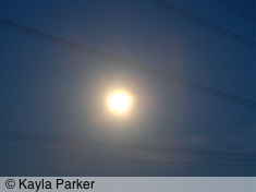 Kayla's handheld photo of the full moon, from bedroom window through telephone wires
